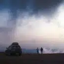 two person standing near SUV during day