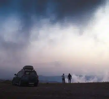 two person standing near SUV during day