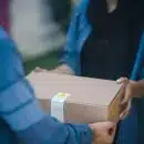 person giving brown box