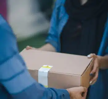 person giving brown box