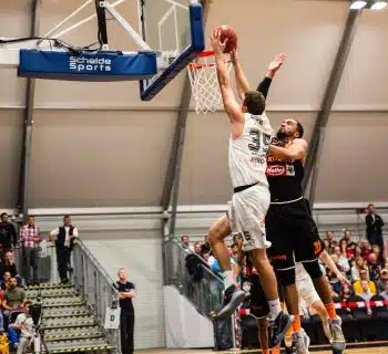 man holding ball dunk in ring