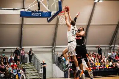 man holding ball dunk in ring