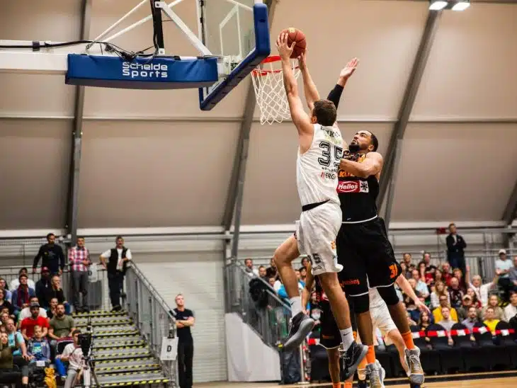 man holding ball dunk in ring